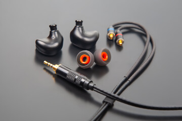 Premium in-ear headphones with modular design, including black earbuds, colorful ear tips, and a...