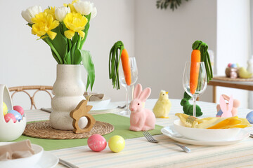 Festive table setting with different Easter decoration in kitchen, closeup