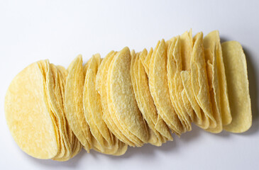 A potato chip or crisp is a thin slice of  potato that has been deep fried baked isolated on white background.

