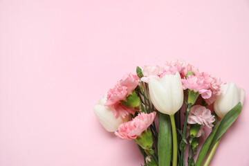 Bouquet of different beautiful flowers on pink background. Mother's Day celebration