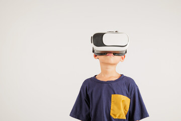 Smiling young kid boy confidence excited wear VR headset device during virtual reality experience isolated white background, Asian happy portrait primary child playing video game studio shot