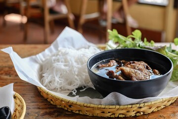 Bun cha Hanoi with grilled pork meatballs and a basket of fresh herbs and rice noodles at VN Street Foods, a North Vietnamese street food restaurant in Sydney’s inner west - Marrickville, NSW 