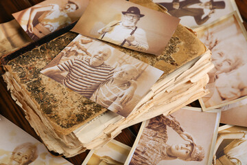 Old album with photos of relatives on table. Concept of family tree