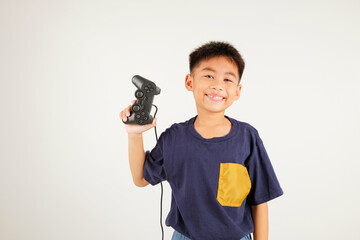 Asian happy portrait young kid boy smile lifestyle games technology holding joystick game playing...
