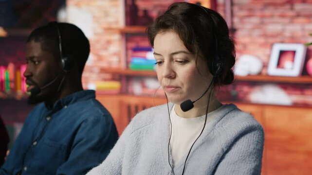 Customer support workers assisting clients to meet outbound call quotas and sales targets. Call center agents contacting prospects to inform them about new products, camera A