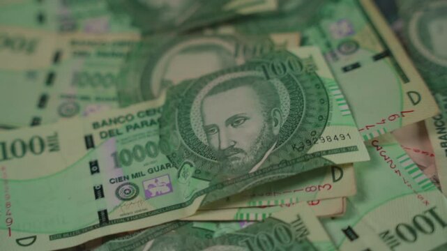 One-hundred-thousand guaran&iacute; bill from Paraguay with a close-up pan