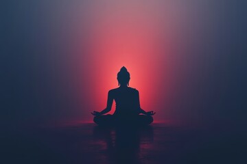 Silhouette of buddha statue in meditation with red and blue backdrop