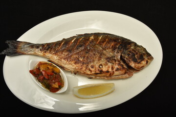 Grilled carp fish ,Dorada (Sparus aurata) with lemon in Bistrita ,Romania