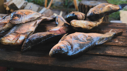 Fish drying on weathered wooden surface, revealing traditional preservation technique in open air...