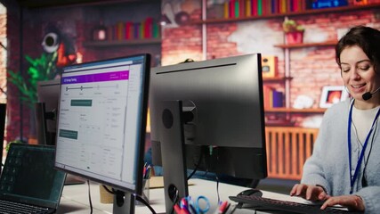 Teamworking cheerful call center agents tracking shipments in office. Upbeat customer center colleagues use software to locate clients packages and provide status updates, camera B close up