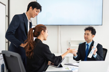 Strategic Discussion and Engagement. A professional team analyzing data together, fostering a collaborative environment.