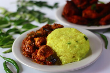 Boiled and mashed tapioca served with spicy chicken curry and crispy fried fish