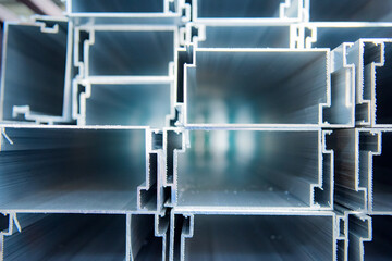 Finished aluminum product cross-sections are stacked on shelves or in warehouses in aluminum...