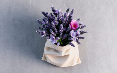 Aromatic purple lavender blooms elegantly arranged in a simple beige sack, presenting a natural and calming floral display.