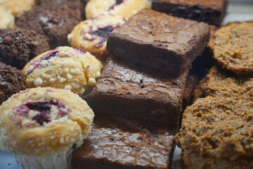 Delicious baked goods assortment with brownies and muffins on display