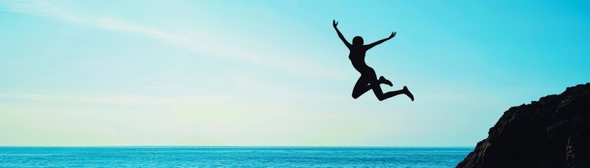 A silhouette of a person jumping joyfully against a serene ocean backdrop, embodying freedom and adventure.