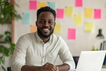 Portrait of a happy businessman with a laptop in the office. The color scheme is predominantly white, with a blurred background, creating a clean and minimalist concept with ample copy space