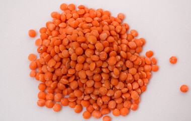 Red lentils pile isolated. Dry orange lentil grains, heap of dal, raw daal, dhal, masoor, Lens culinaris or Lens esculenta on white background