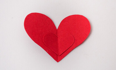 Red paper Valentines Day heart against a white background, love concept. Flat lay