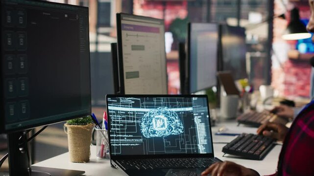 Call center employee using AI chatbot at office desk to reply to common customer queries, close up. Customer service staff member at work generates automated responses to clients using AI, camera A
