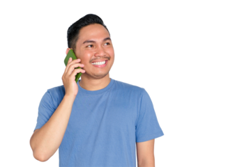Happy young Asian man smiling while talking on mobile phone, looking up with joyful expression, wearing casual blue shirt, isolated on transparent background