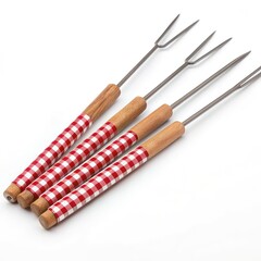 Fototapeta premium Four barbecue forks with red and white checkered handles, isolated on a white background, perfect for grilling and cooking outdoors.