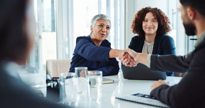 Happy, business people and meeting with handshake for agreement, deal or partnership at office. Businessman, woman or colleagues shaking hands with team for introduction or greeting at workplace