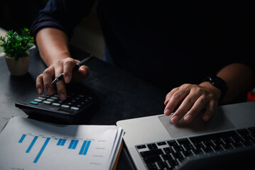 Accounting process with calculator, business chart and laptop, small business finance, planning strategy, and personal or professional financial management. Business bookkeeping payroll and tax.