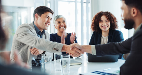 Happy, business people and applause with handshake for good deal, partnership or agreement at...