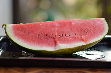 slices of ripe red watermelon at the table
