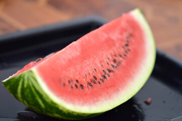 slices of ripe red watermelon at the table
