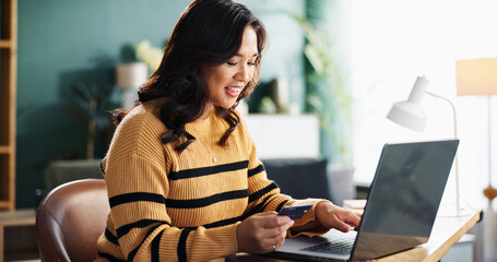 Happy, asian woman and laptop with credit card for online shopping, payment or banking at home. Female person, shopper or customer with debit or computer for remote transaction or ecommerce at house