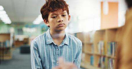 Fototapeta premium Children, counseling or listening with boy and therapist in library of school for assessment or review. Development, education and occupational therapy with student speaking to counselor for support