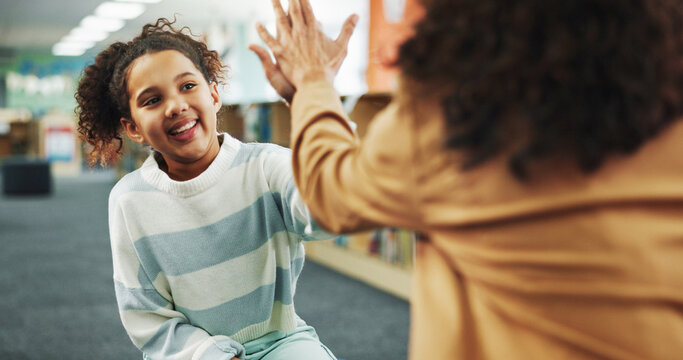 High five, smile and child with teacher, school and celebration for knowledge, growth and development. Elementary, student and happy for learning in library, scholarship or conversation for education