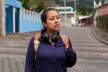Fototapeta premium A young woman deeply contemplating her life while sitting on a bustling city street