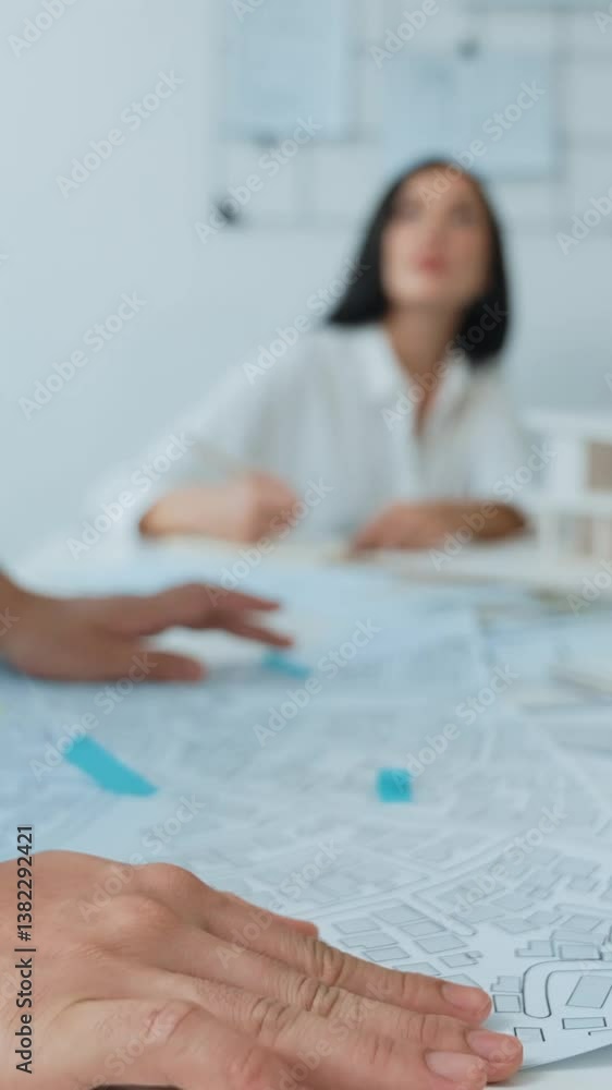 Poster skilled caucasian interior designer working with house model while discussing with asian architect e