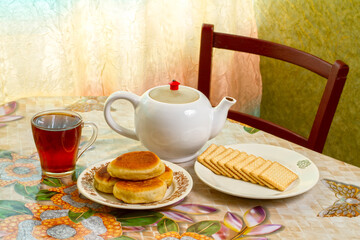 Tea with pies and cookies on the table. Kettle, cup and homemade pastries on the table.