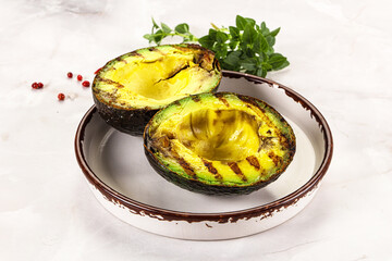 Sliced fresh avocado on the grill
