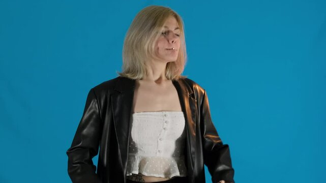 Angry young woman waves arms furiously silently conveying frustration. Unsatisfied blonde female jumps shaking up slow motion