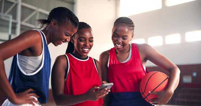 Laughing, basketball or friends with phone in college on social media for break or entertainment. Happy, women and African athletes on court with mobile for workout, funny joke or fitness training