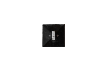 Old black plastic light switch is isolated. Vintage electrical toggle switch with visible wear.