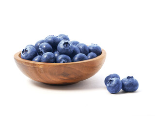 Blueberries in wooden bowl isolated on white background