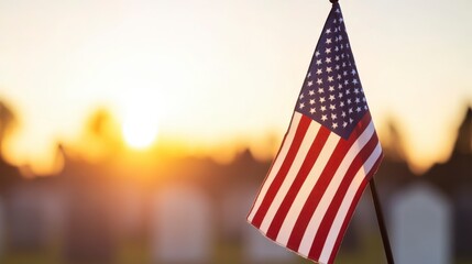 Lone American Flag Waving at Sunrise Over a Peaceful Graveyard Landscape