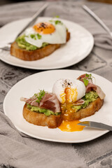 Toast with avocado, prosciutto and poached egg