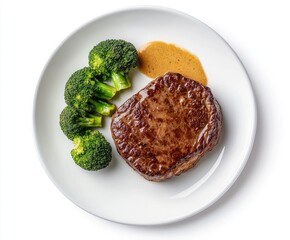 Grilled steak with broccoli and sauce.  A perfectly cooked steak, accompanied by fresh broccoli florets and a rich, savory sauce, presented on a white plate