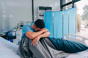 Lonely man silhouette sitting on the bed feeling depressed and stressed in the dark bedroom, Depression and anxiety disorder concept