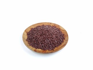 Chocolate meshes on wooden plate isolated on white background 