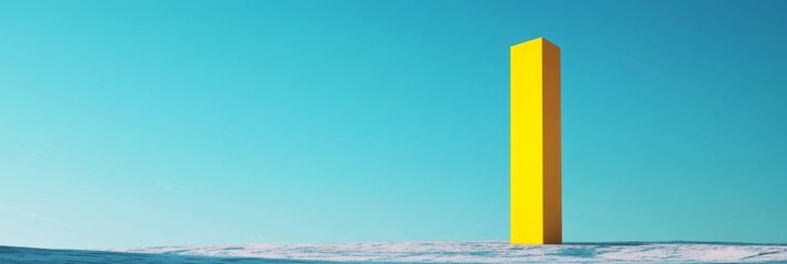 Yellow rectangular object stands on a light surface against a