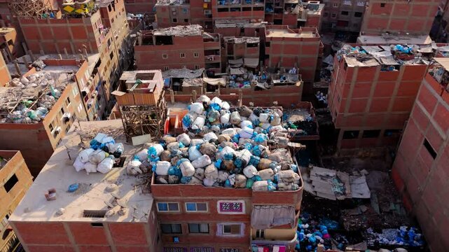Pile Of Garbage Dumped On The Rooftop Of Building In Manshiyat Naser, Cairo, Egypt. - aerial shot