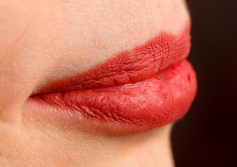 Fototapeta premium A woman's lips are painted red